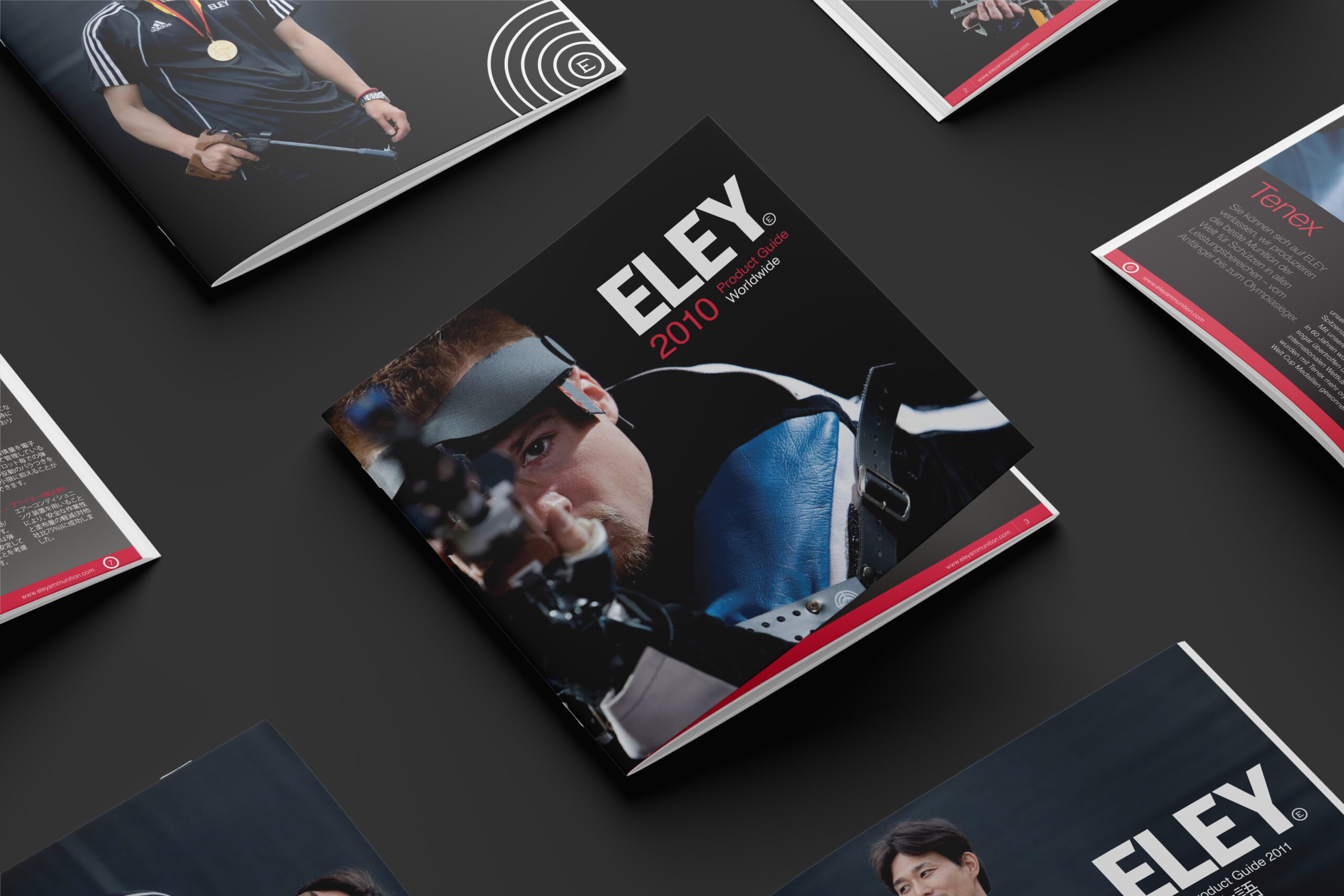 A selection of Eley product guides are arranged in a grid on a dark background. At the centre of the image is the 2010 Worldwide product guide with an image of a competitive rifle shooter taking aim.