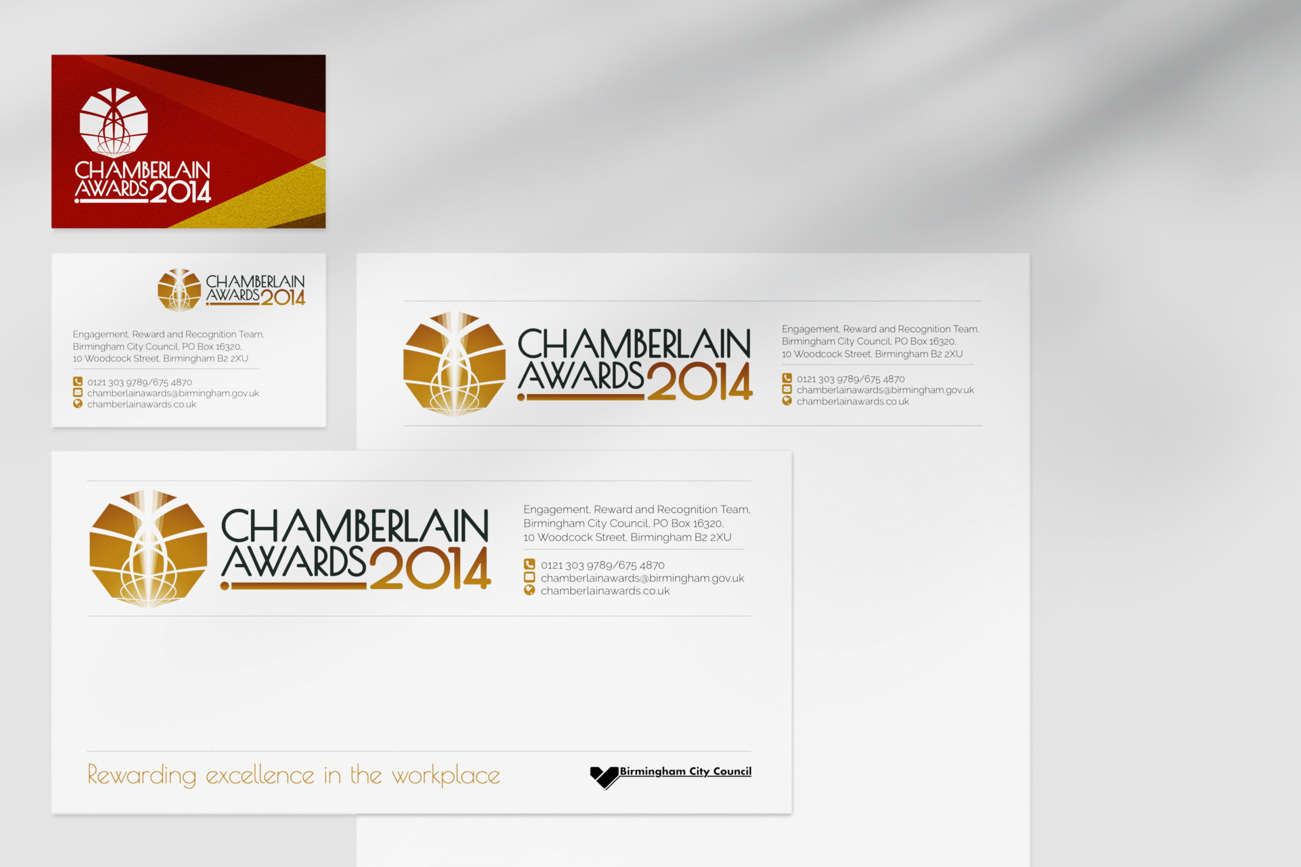 A Chamberlain Awards 2014 business card, compliment slip and letterhead arranged in a grid on a light grey background