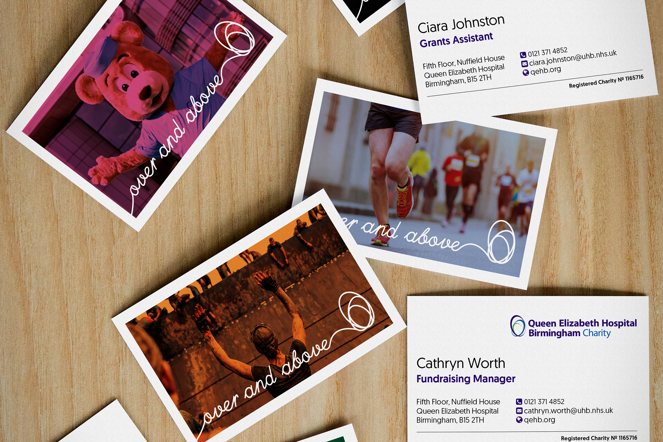 Business cards with a colourful variety of images are scattered on a wooden desktop. Each card incorporates a different image overlaid with a colour wash and the 'Over and above' charity strapline.